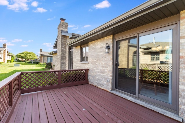 wooden terrace with a lawn