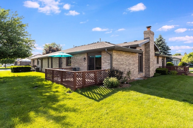 back of house featuring a lawn and central air condition unit