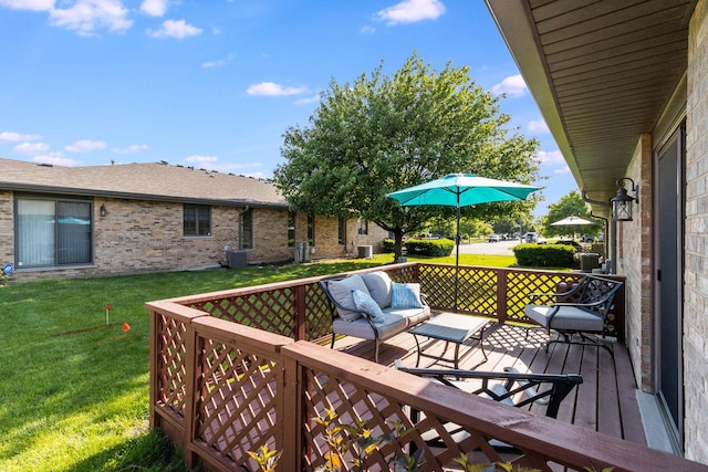 wooden deck featuring central air condition unit and a lawn