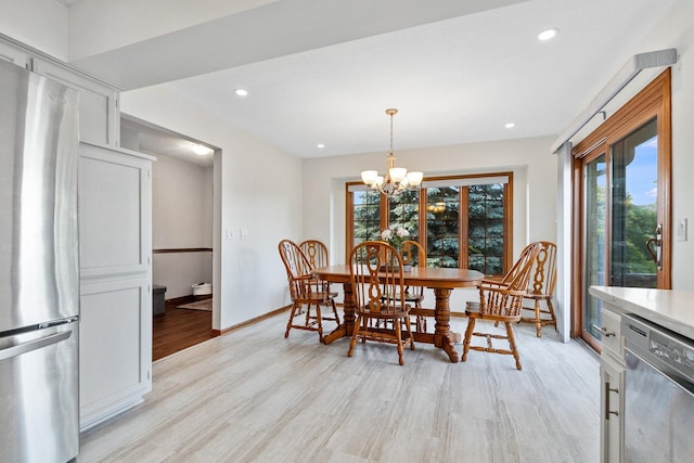 dining room with a notable chandelier and light hardwood / wood-style floors