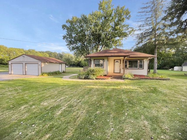 single story home featuring a front yard, an outbuilding, and a garage