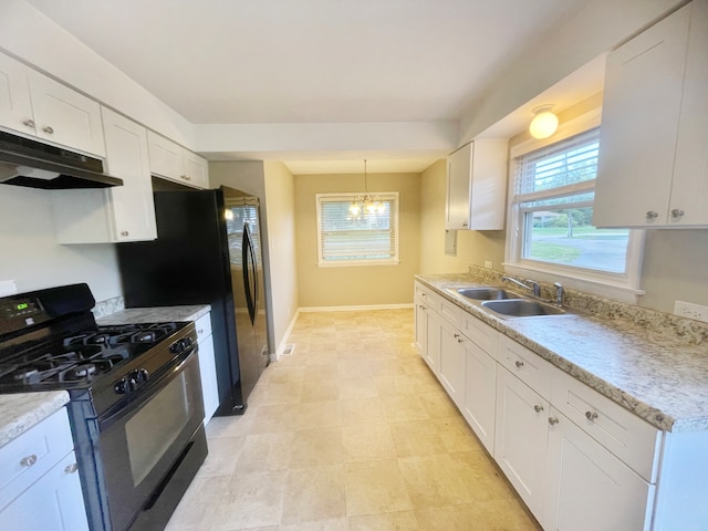 kitchen with black range with gas cooktop, sink, a notable chandelier, pendant lighting, and white cabinets