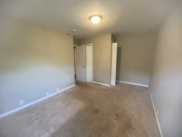 unfurnished bedroom with light colored carpet