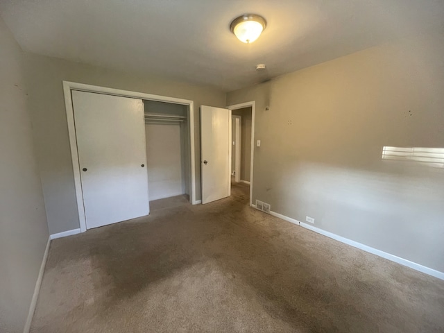 unfurnished bedroom featuring a closet and carpet