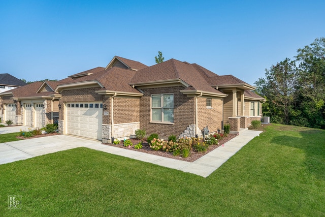 view of front of home featuring a garage and a front lawn