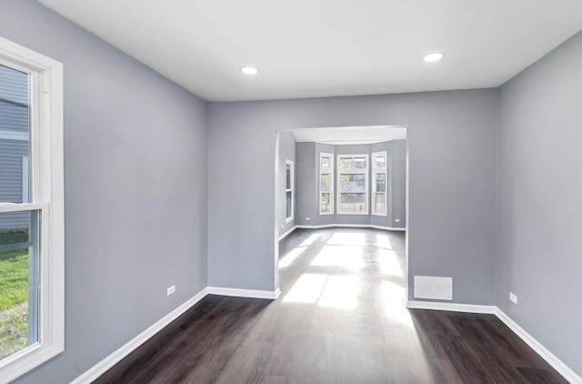 interior space with visible vents, recessed lighting, dark wood finished floors, and baseboards