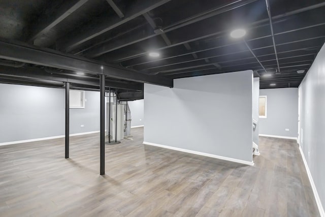 finished basement featuring baseboards and wood finished floors