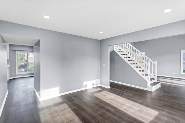 spare room with recessed lighting, baseboards, wood finished floors, and stairway