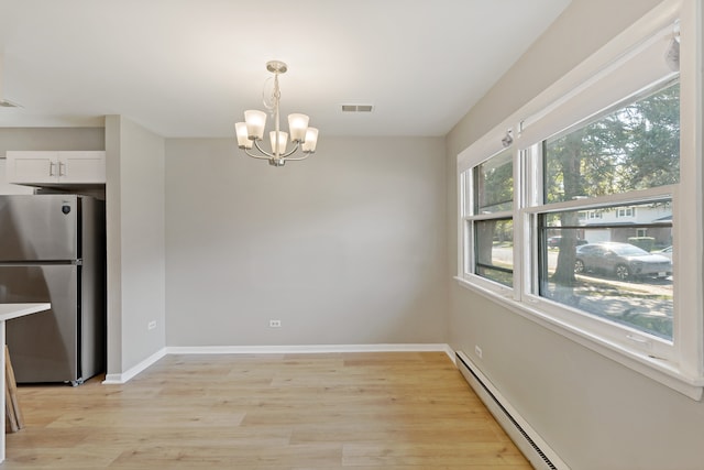 unfurnished dining area featuring a notable chandelier, light hardwood / wood-style flooring, and a baseboard radiator