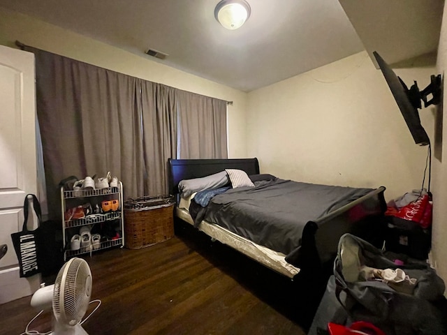 bedroom with dark wood-type flooring