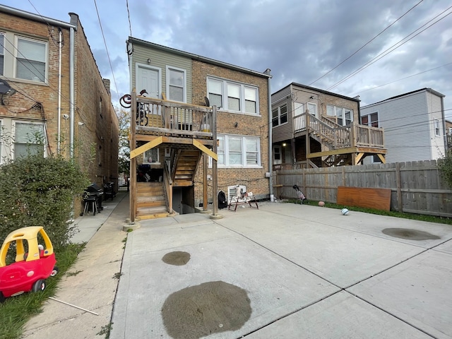 rear view of property featuring a deck