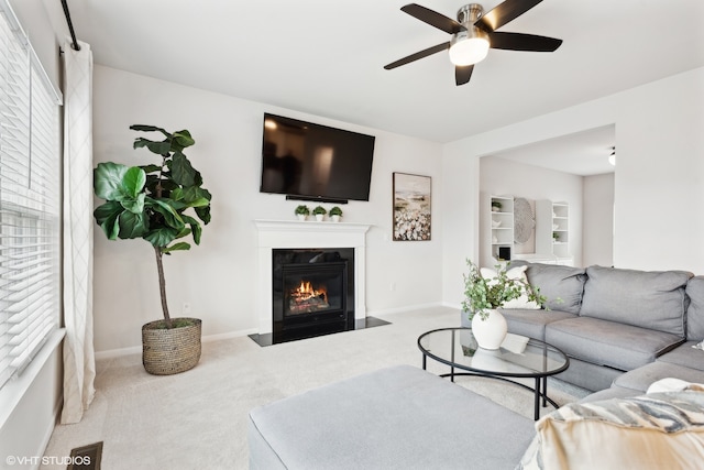 living room with ceiling fan and carpet floors