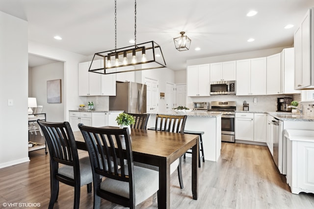 dining area featuring light hardwood / wood-style floors and sink