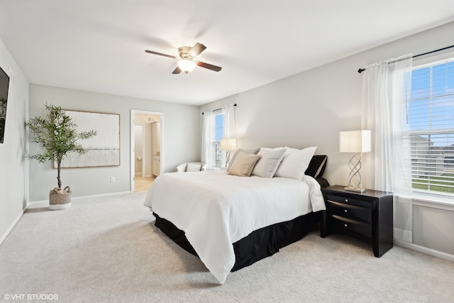 bedroom featuring light carpet, multiple windows, and ceiling fan