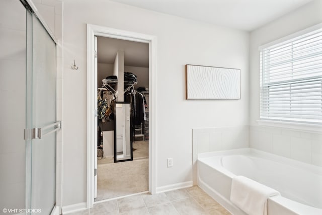 bathroom featuring tile patterned flooring and independent shower and bath