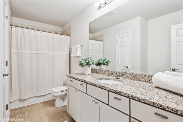 bathroom with vanity, tile patterned floors, and toilet