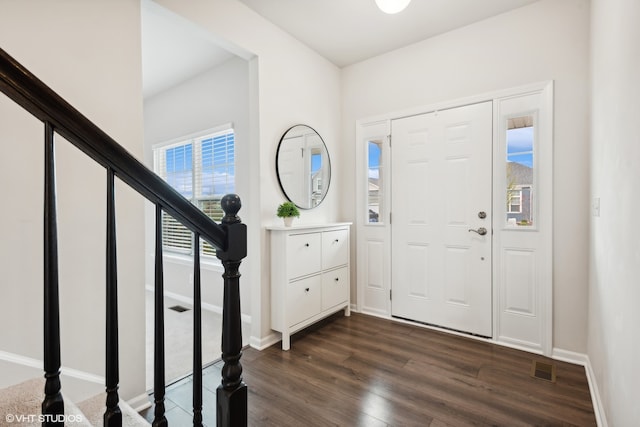 entryway with dark hardwood / wood-style floors