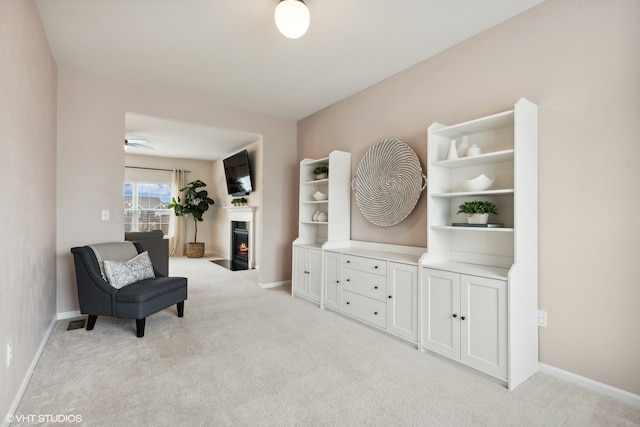 sitting room featuring light colored carpet