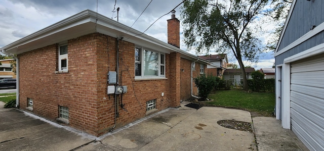 view of home's exterior with a garage and a patio area