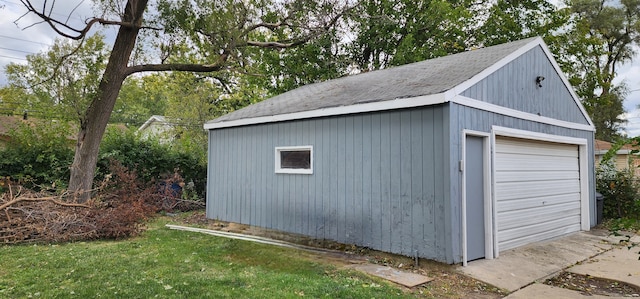 view of outdoor structure with a garage and a yard