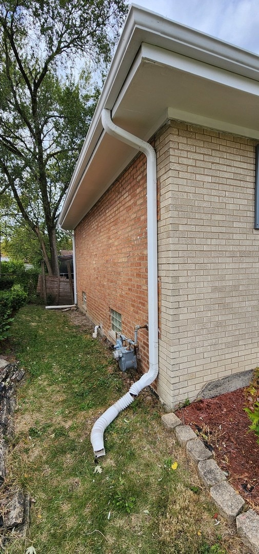 view of side of property with a lawn