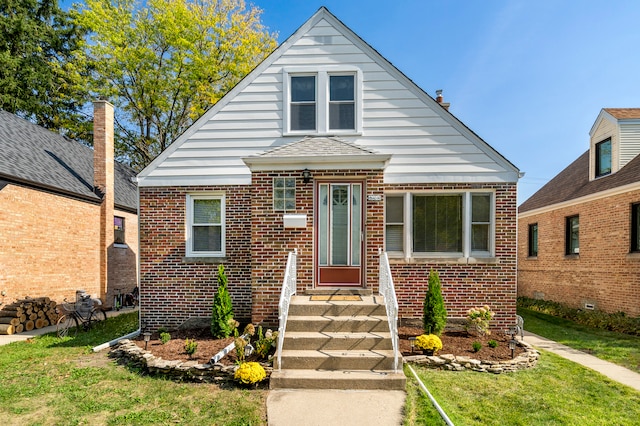 bungalow-style house with a front lawn