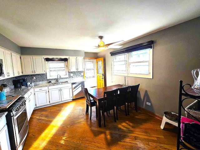 kitchen with white cabinetry, a healthy amount of sunlight, and dark hardwood / wood-style flooring