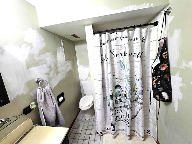 bathroom featuring vanity, curtained shower, toilet, and tile patterned flooring