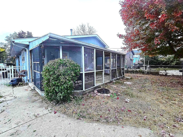 view of side of home featuring a sunroom