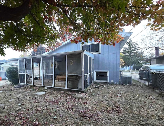 back of property with a sunroom and cooling unit