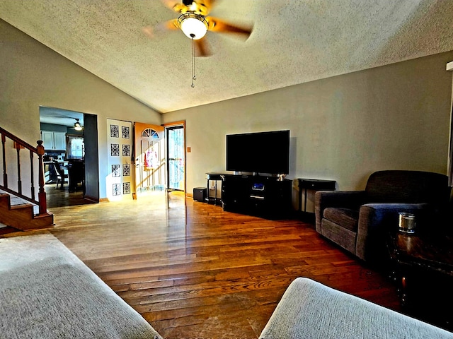 living room featuring ceiling fan, a healthy amount of sunlight, and dark hardwood / wood-style flooring