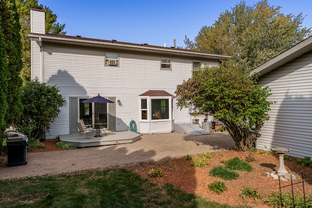 back of property featuring a wooden deck