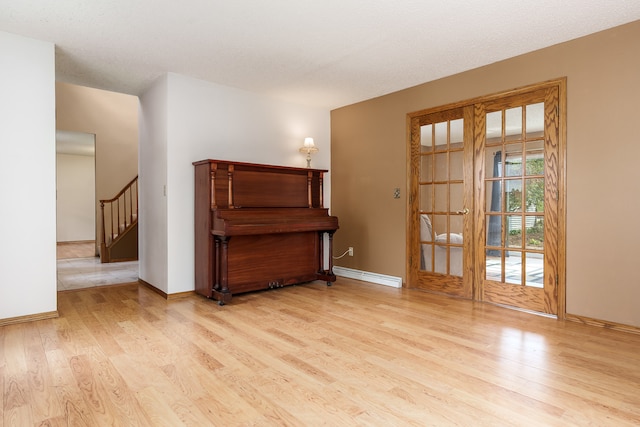 miscellaneous room with a textured ceiling and light hardwood / wood-style flooring