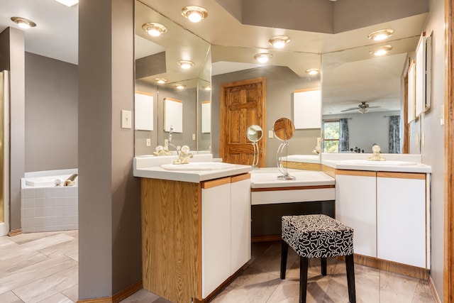 bathroom with tiled bath, vanity, and ceiling fan