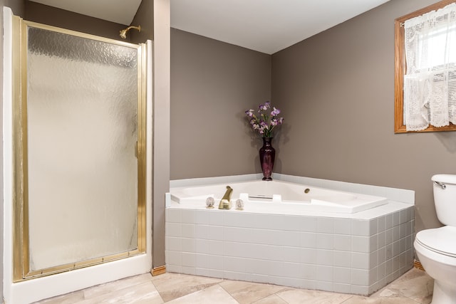 bathroom featuring tile patterned flooring, separate shower and tub, and toilet