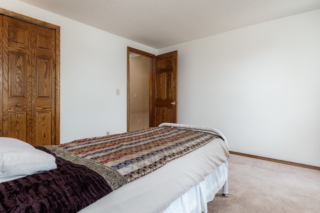 bedroom with carpet floors and a textured ceiling