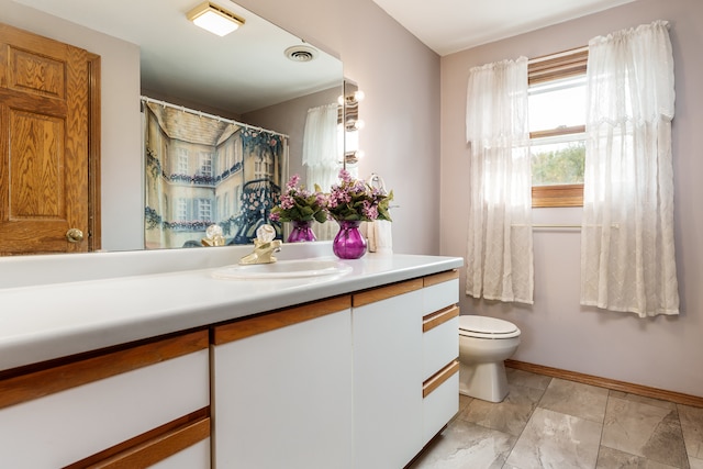 bathroom featuring vanity and toilet