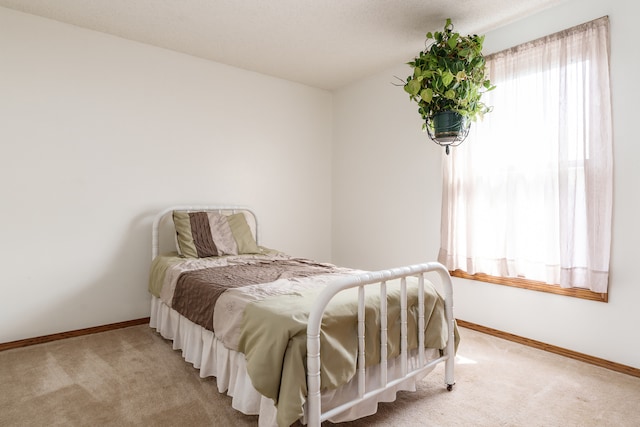 bedroom featuring light carpet