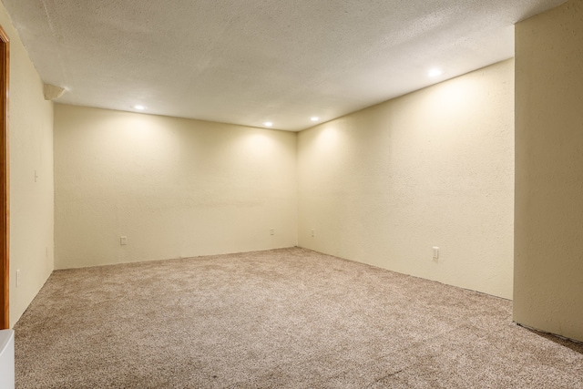 spare room with carpet flooring and a textured ceiling