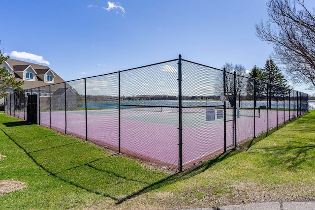 view of sport court featuring a lawn