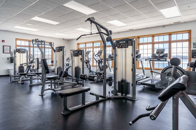 gym with a paneled ceiling