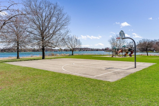 view of sport court with a water view, a playground, and a yard