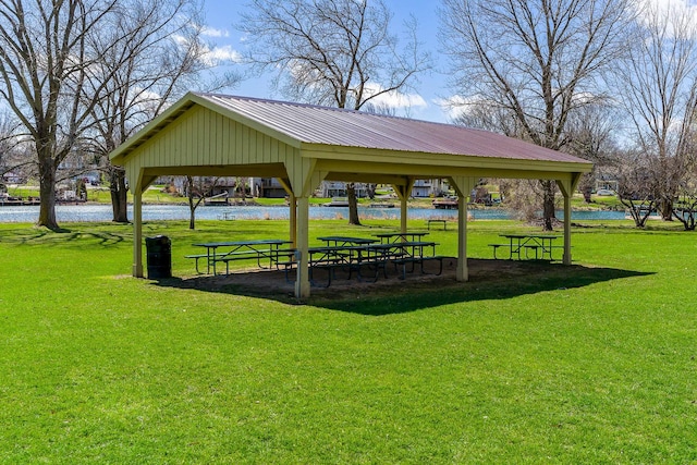 view of community featuring a gazebo, a water view, and a yard