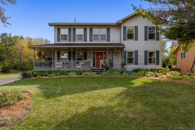 view of front of house with a front yard and covered porch