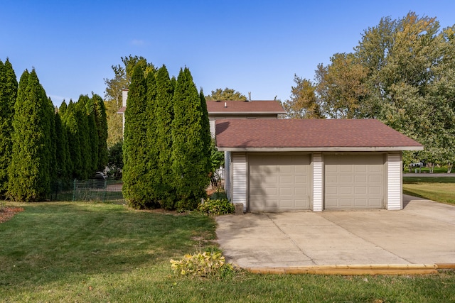 garage featuring a yard