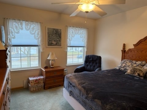 bedroom with light carpet and ceiling fan