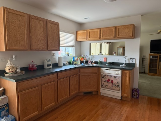 kitchen with dishwasher, light wood-type flooring, sink, and ceiling fan