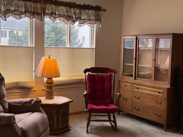 carpeted living room with ceiling fan