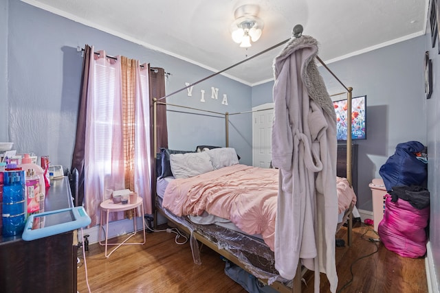 bedroom featuring hardwood / wood-style flooring and ornamental molding