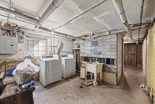 basement with electric panel and washer and dryer